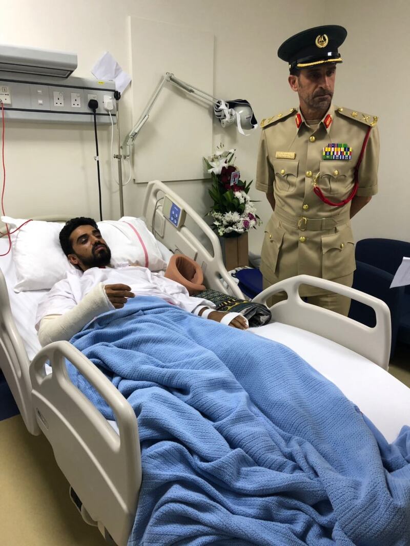 Maj Gen Abdullah Al Marri, commander-in-chief of Dubai Police, visits policeman Mohammed Shakal at Rashid Hospital after he was run over helping a woman whose car had broken down on the side of the road. Courtesy Dubai Police