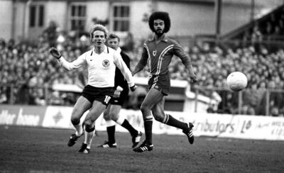 Karl-Heinz Rummenigge of West Germany and George Berry of Wales keep their eyes on the ball during an international match in 1979. Berry was the inspiration for the style of image used in the My Cymru, My Shirt mural. Getty