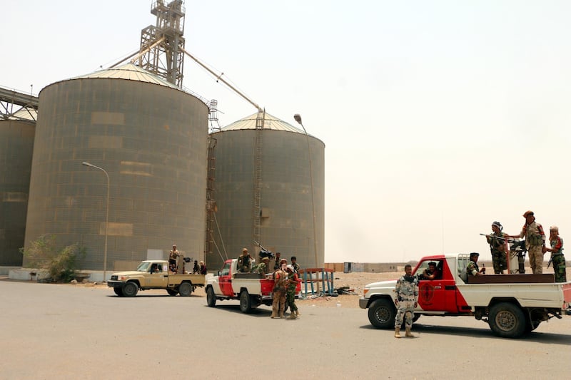 epa07735662 Yemeni government forces guard as a team of the World Food Program (WFP) visits the key grain storage silos in the war-torn city of Hodeidah, Yemen, 23 July 2019. According to repowers, a team of the World Food Program (WFP) visited the key grain storage silos in the port city of Hodeidah, a month after the UN agency began partially suspending aid to the Houthi-controlled areas of Yemen, affecting 850,000 beneficiaries only in the capital Sanaâ€™a. The UN agency delivers monthly rations or money to 10.2 million people of Yemen's 26-million population.  EPA/NAJEEB ALMAHBOOBI