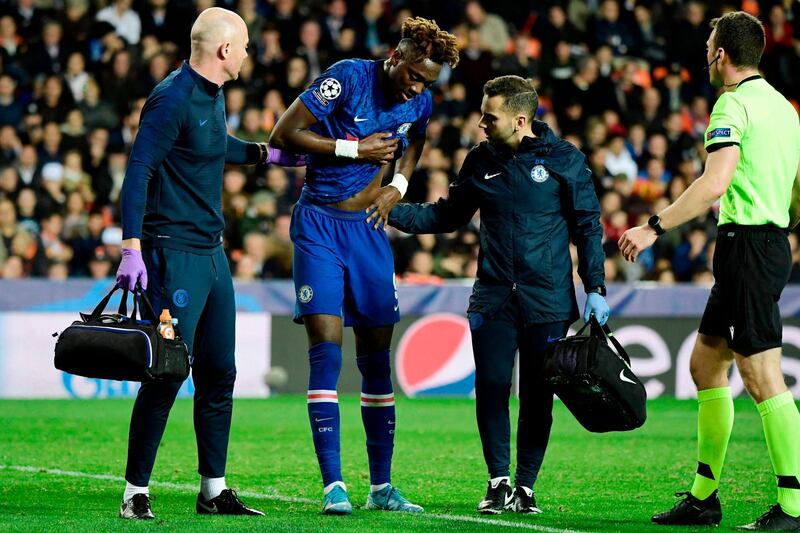 Chelsea striker Tammy Abraham is helped from the pitch after injuring his hip against Valencia in the Champions League. AFP