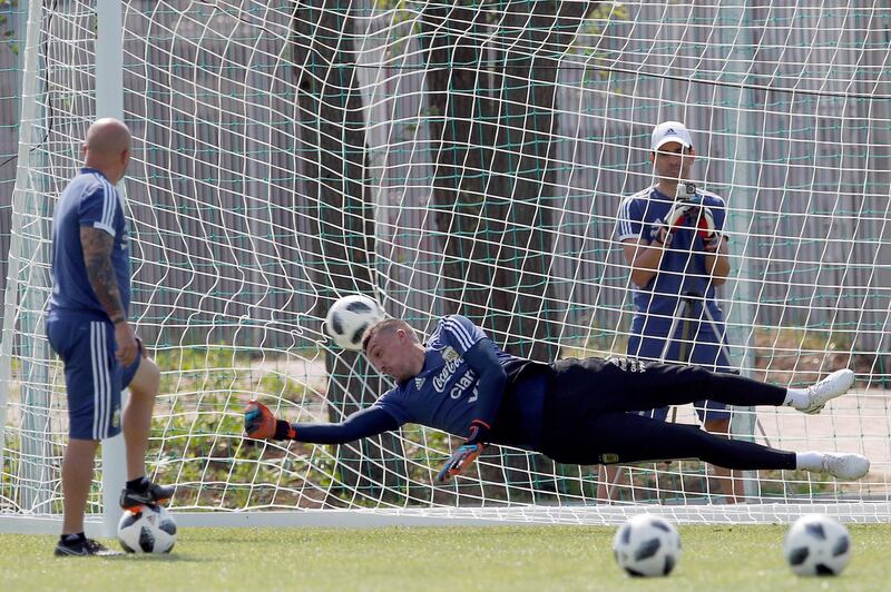 Argentina's coach Jorge Sampaoli, left, watches his goalkeeper Franco Armani during a training session. Alberto Estevez / EPA