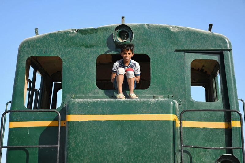 A boy sits on a locomotive in the city of Nasiriyah in Iraq's southern Dhi Qar province. AFP