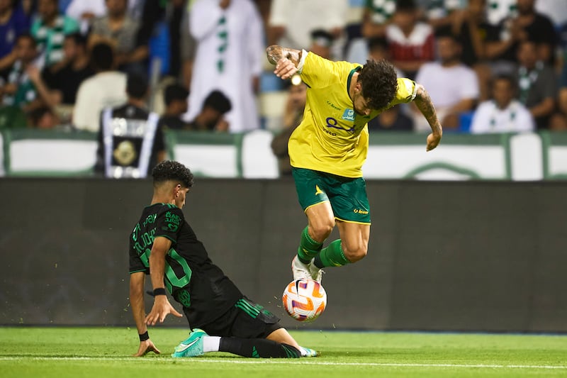 Al Khaleej forward Ivo Rodrigues fights for the ball with Al Ahli midfielder Ziyad Al Johani. Getty