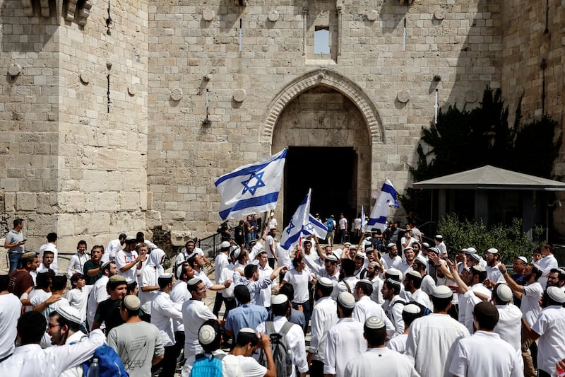 Israelis wave flags and chant outside Damascus Gate. Reuters