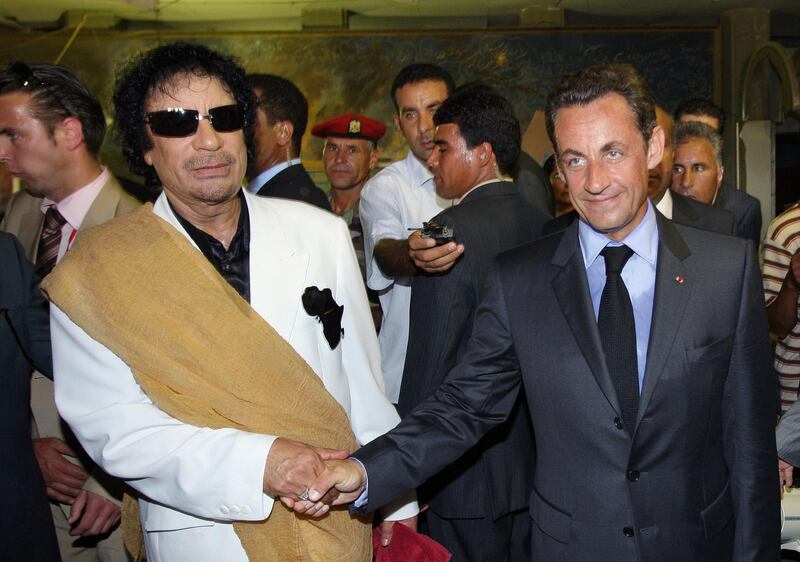(FILES) In this file photo taken on July 25, 2007 French president Nicolas Sarkozy shakes hands with Libyan leader Moamer Khadafi (L) upon his arrival for an offcial visit to Libyain Tripoli.  
Former French president Nicolas Sarkozy has been called in for questioning by investigators looking into suspected Libyan financing of his 2007 election campaign, a source close to the inquiry told AFP on March 20, 2018. / AFP PHOTO / Patrick KOVARIK
