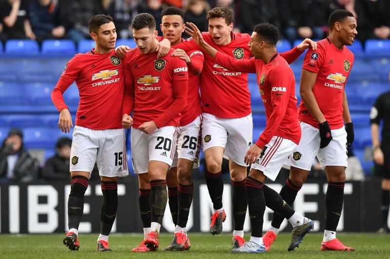 Manchester United's Diogo Dalot, second left, celebrates after scoring their second goal. AFP