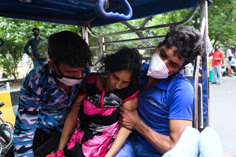 A patient collapses outside a Sikh temple providing free medical oxygen to patients in Ghaziabad. AFP