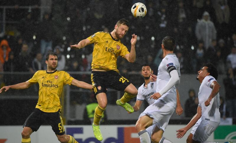 Arsenal's German defender Shkodran Mustafi (C) heads the ball to score a goal during the UEFA Europa League Group F football match between Vitoria Guimaraes SC and Arsenal FC at the Dom Afonso Henriques stadium in Guimaraes on November 6, 2019. / AFP / MIGUEL RIOPA
