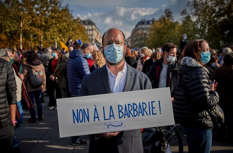 PARIS, FRANCE - OCTOBER 18: Protestors during an anti-terrorism vigil at Place de La Republique for the murdered teacher Samuel Paty who was killed in a terrorist attack in the suburbs of Paris on October 18, 2020 in Paris, France. Thousands of people turned out to show solidarity and express their support for freedom of speech in the wake of Friday's attack. France launched an anti-terrorism investigation after the October 16 incident where police shot the 18 year-old assailant who decapitated the history-geography teacher for having shown a caricature of prophet Mohamed as an example of freedom of speech at the College Bois d'Aulne middle-school.  (Photo by Kiran Ridley/Getty Images) (Photo by Kiran Ridley/Getty Images)