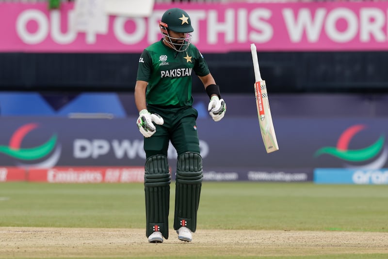 Frustrated Pakistan batter Babar Azam throws his bat after losing his wicket. He hit one six and one four in his innings of 33. AP