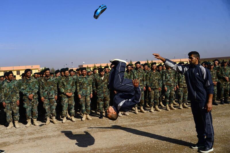 TOPSHOT - An Afghan National Army (ANA) soldier demonstrates his skills during a graduation a ceremony in a military base in the Guzara district of Herat province on December 2, 2020. / AFP / HOSHANG HASHIMI
