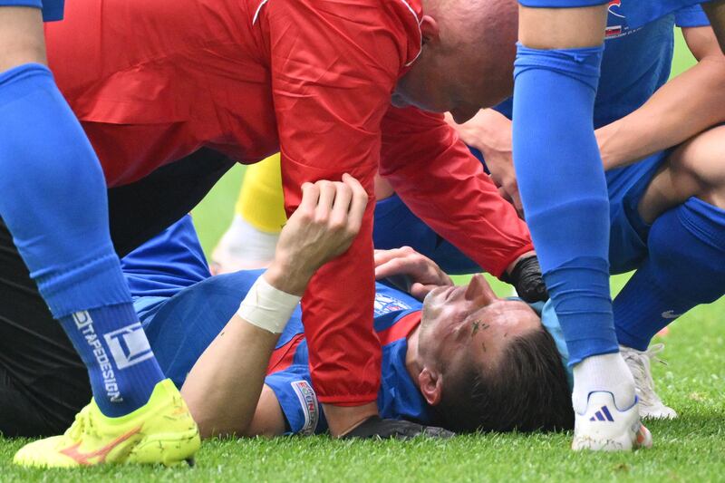 Slovakia's defender Peter Pekarik receives medical attention after a clash of heads with Ukraine's Oleksandr Zinchenko. AFP