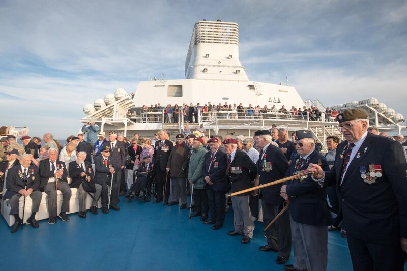 Normandy veterans attend a at-sea wreath laying ceremony on the deck of the Brittany ferry from Portsmouth to Caen.