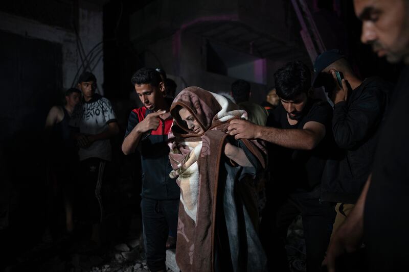 Palestinians evacuate injured members of the Abu Al Anon family after an Israeli air strike hit their home in the Rafah refugee camp, southern Gaza. EPA