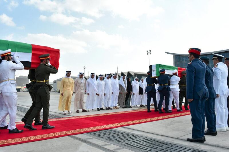 Sheikh Mansour bin Zayed, Deputy Prime Minister and Minister of Presidential Affairs, and Sheikh Abdullah bin Zayed, Minister of Foreign Affairs, greet the bodies of the men as they land at Al Bateen Airport to full honours. Wam