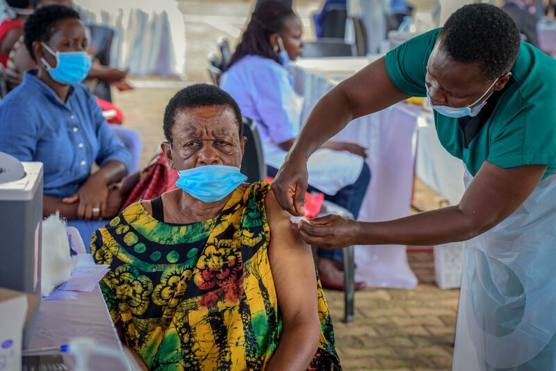 A woman receives a Covid-19 vaccination at the Kololo airstrip in Kampala, Uganda. AP Photo / Nicholas Bamulanzeki
