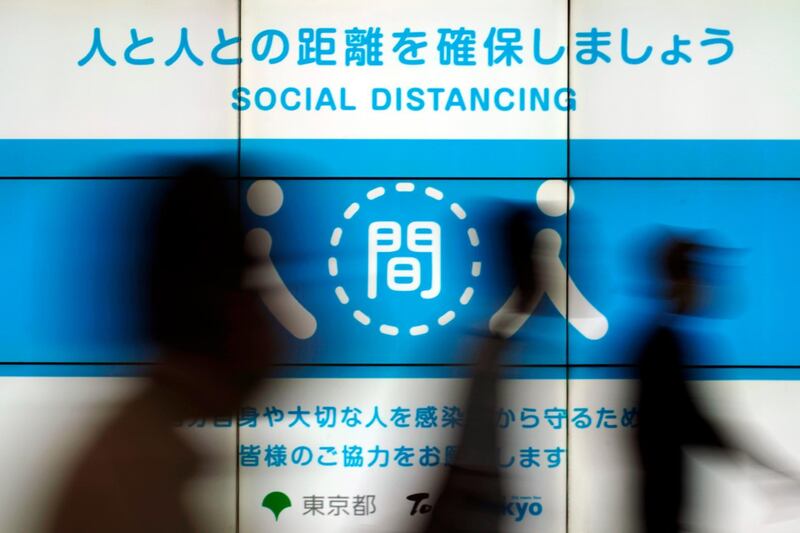 A public awareness notice in Tokyo reminds people to practise social distancing. AP Photo