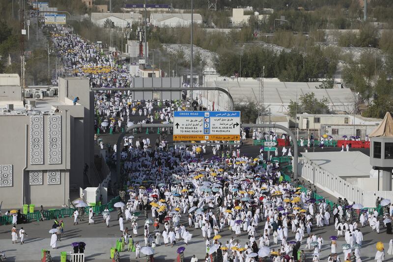 Muslim pilgrims walk on the plains of Mount Arafat. EPA