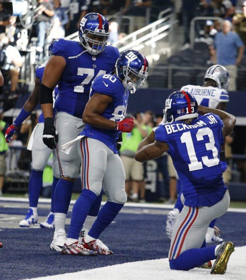 New York Giants player Victor Cruz, centre, dances in the end zone to celebrate a touchdown against the Dallas Cowboys. Larry W. Smith / EPA