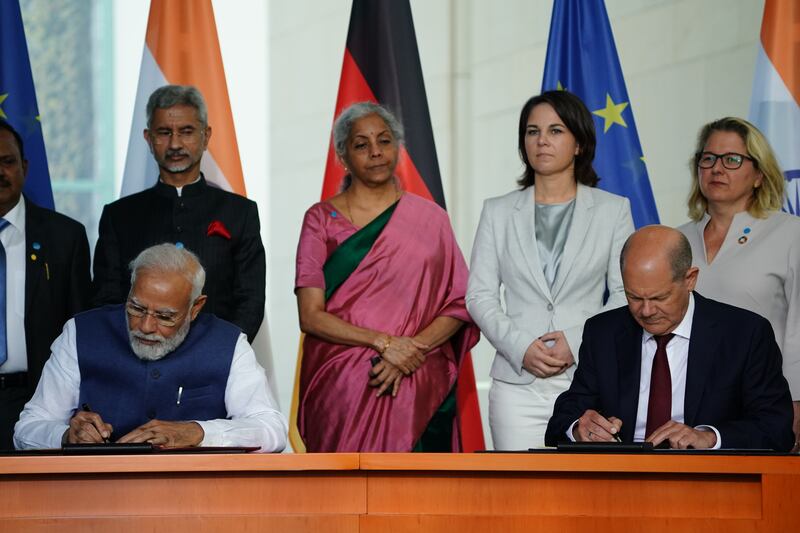 The leaders sign contracts at the Chancellery in Berlin. Getty Images