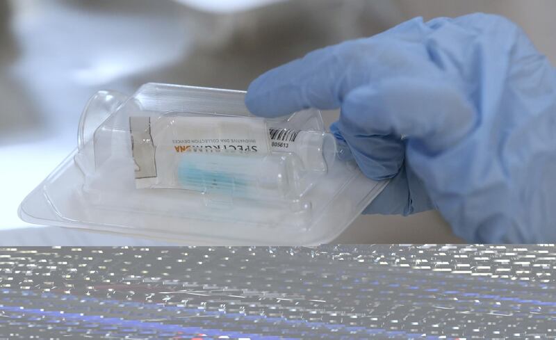 An employee at Spectrum Solutions assembles Covid-19 saliva test kits in Draper, Utah, USA. AFP