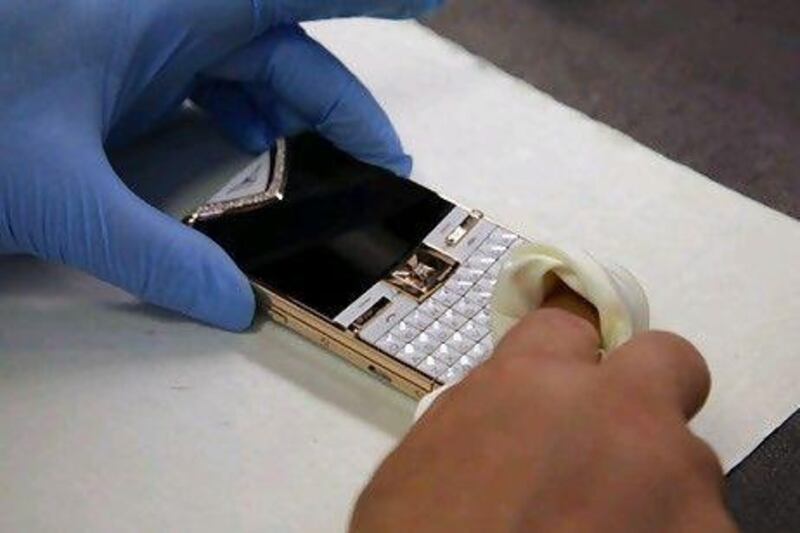A technician polishes a Vertu Constellation mobile handset. Bloomberg News