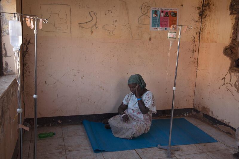 A woman who fled the conflict in Ethiopia's Tigray region waits to get treatment at a clinic in Umm Rakouba refugee camp in Qadarif, eastern Sudan. AP