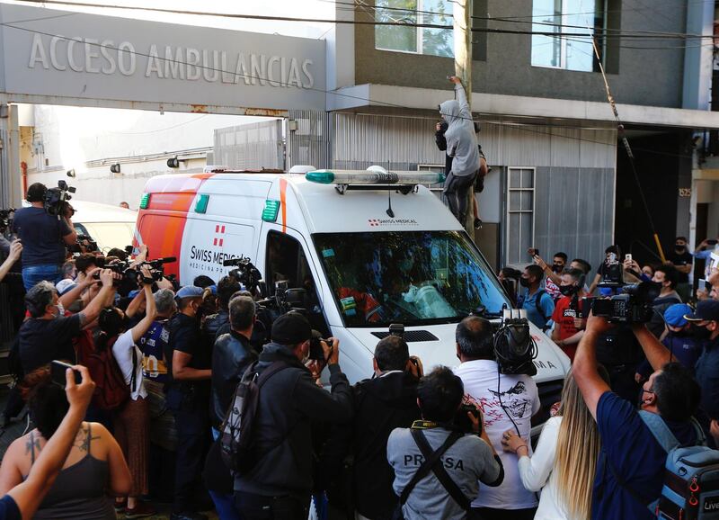 The ambulance carrying Diego Maradona drives out of the Clinica Olivos in Vicente Lopez. Getty