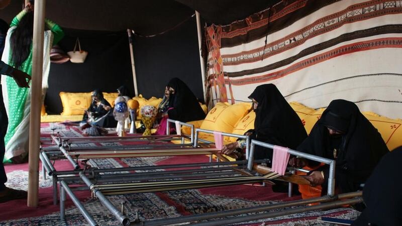 Emirati women weave tapestries on looms at the Tan-Tan Moussem Festival in Morocco. Courtesy TCA