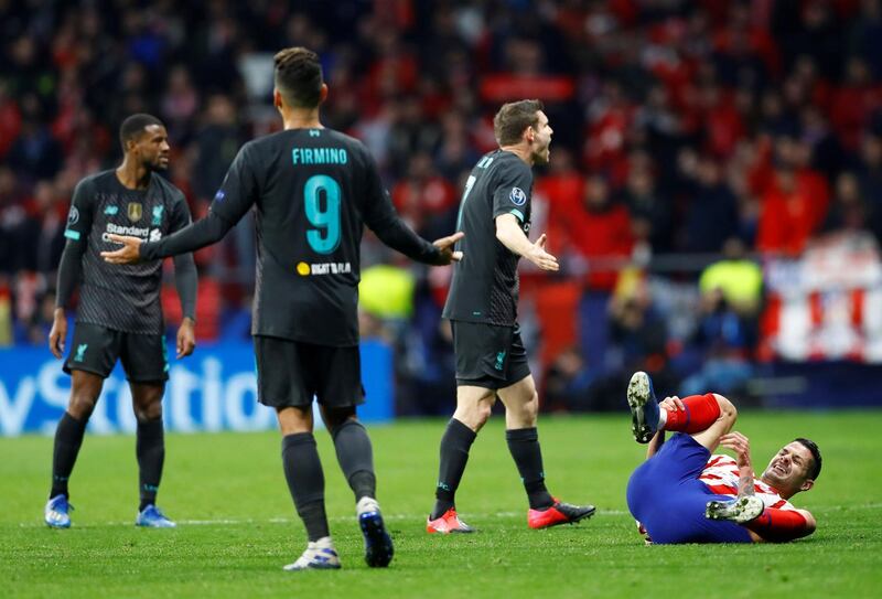 Atletico Madrid's Vitolo reacts after going down as Liverpool's James Milner gestures to the referee. Reuters