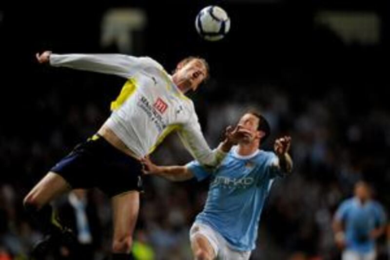 Peter Crouch of Tottenham Hotspur beats Wayne Bridge of Manchester City to the ball during the Barclays Premier League match between Manchester City and Tottenham Hotspur at the City of Manchester Stadium on May 5, 2010 in Manchester, England.