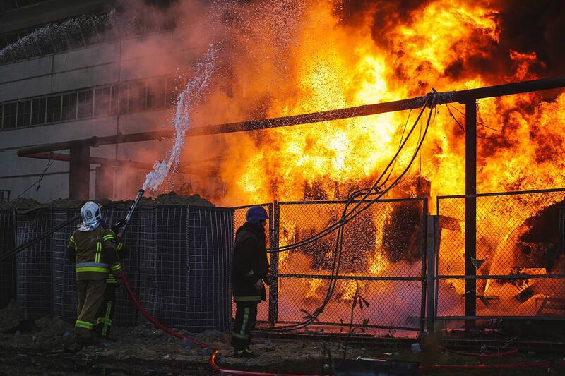 Emergency workers tackle a fire in Kyiv after Russian shelling. EPA