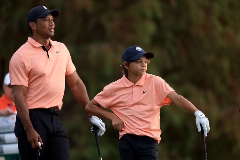 Tiger Woods and Charlie wait to play on the 17th hole. AFP