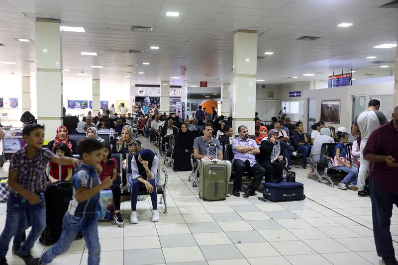 Travellers wait at the Mitiga International Airport after its reopening, in the Libyan capital of Tripoli.  AFP