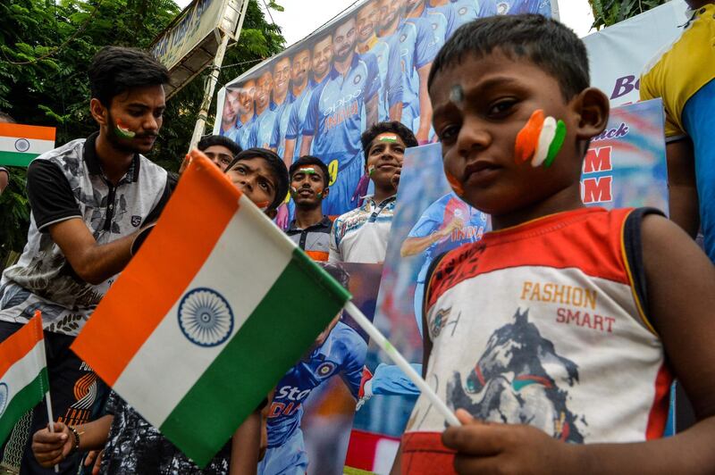 Indian fans paint their faces with colours of the national flag in Siliguri. AFP