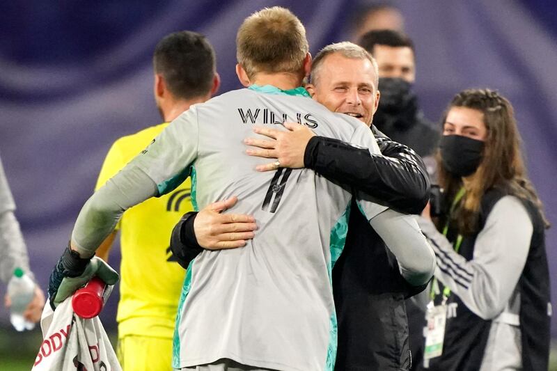 Nashville coach Gary Smith hugs goalkeeper Joe Willis. AP