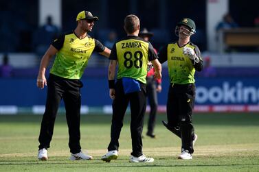 Australia's Adam Zampa (C) celebrates with teammates after the dismissal of Bangladesh's Mustafizur Rahman (not pictured) during the ICC men’s Twenty20 World Cup cricket match between Australia and Bangladesh at the Dubai International Cricket Stadium in Dubai on November 4, 2021.  (Photo by Aamir QURESHI  /  AFP)