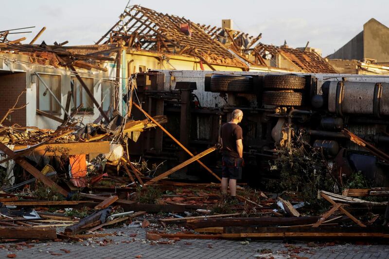 A man surveys the damage a day after a rare tornado struck the village of Moravska Nova Ves in the Czech Republic on June 24, 2021. Reuters