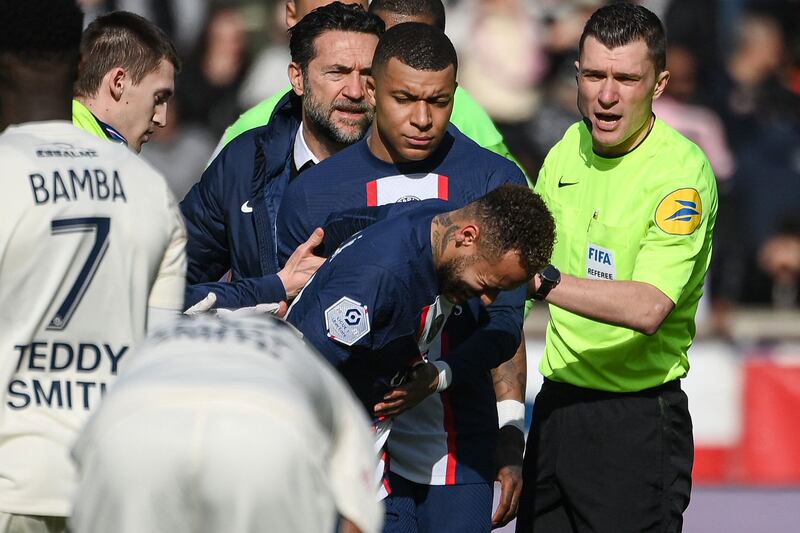 Neymar is comforted by Kylian Mbappe. AFP
