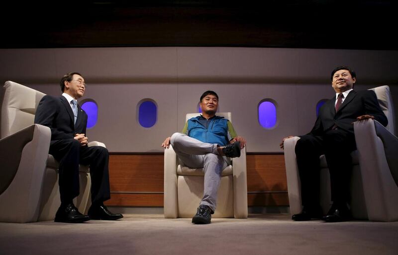 A man sits between the wax figures of UN Secretary-General Ban Ki-moon, left, and Chinese president Xi Jinping, right, at Grevin Wax Museum in Seoul, South KoreKim Hong-Ji / Retuers