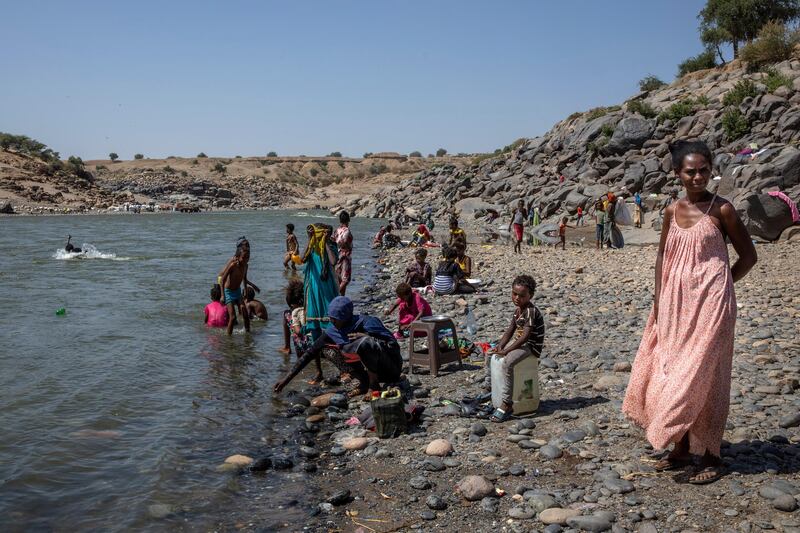 Tigray refugees who fled the conflict in Ethiopia's Tigray rest on the banks of the Tekeze River on the Sudan-Ethiopia border, in Hamdayet, eastern Sudan. AP Photo
