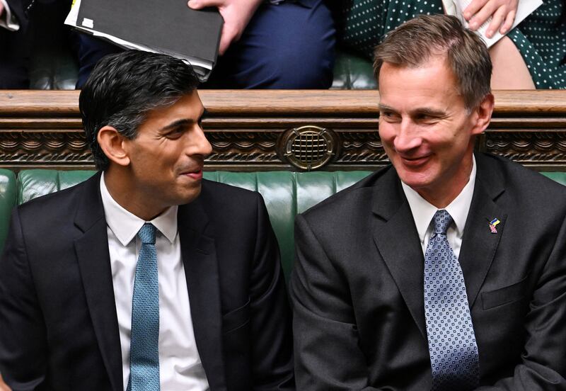 Prime Minister Rishi Sunak, left, and Chancellor Jeremy Hunt have warned the new budget will be tough. AFP
