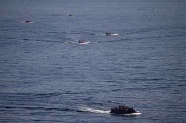 Refugees and migrants are seen onboard eight dinghies as they cross a part of the Aegean Sea from the Turkish coast to reach the Greek island of Lesbos, October 4, 2015. REUTERS/Dimitris Michalakis/File Photo