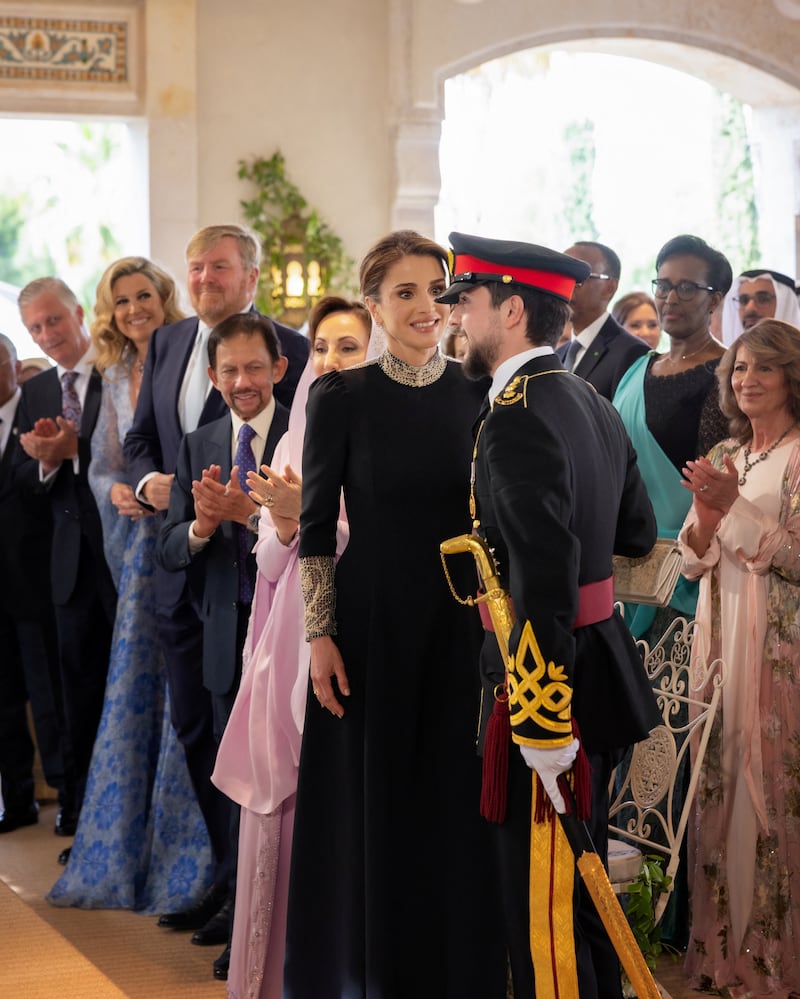 Queen Rania speaks with her son before his wedding to Rajwa Al Saif. Reuters