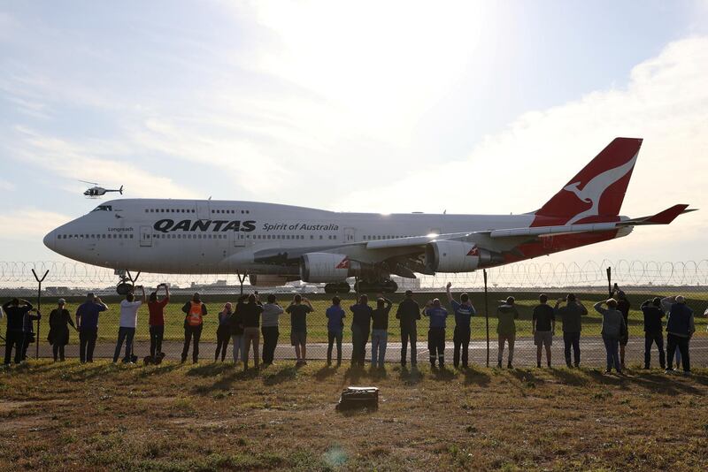 People watch the last Qantas 747 jet depart Sydney Airport. Reuters