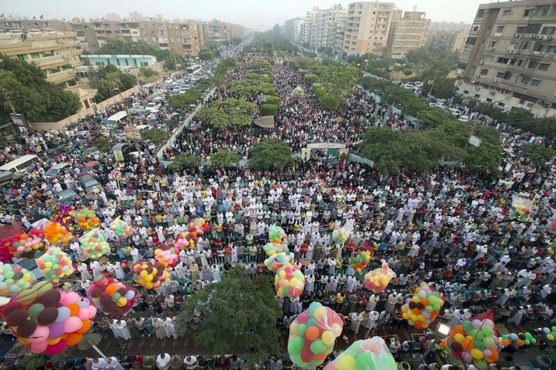 Egyptians attend Eid prayers at a public park outside Al Seddik Mosque in Cairo. Amr Nabil / AP Photo