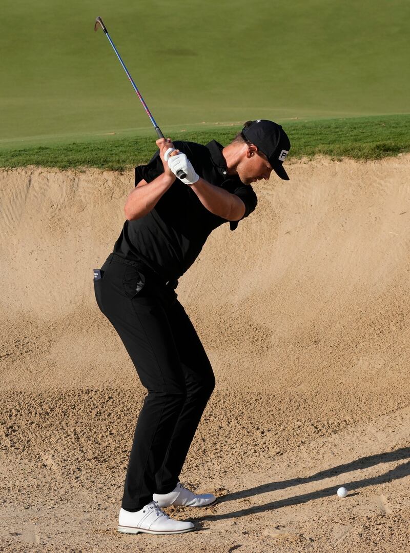 Victor Perez plays his second shot on the 17th hole, which he holed from the bunker for a birdie. AP 