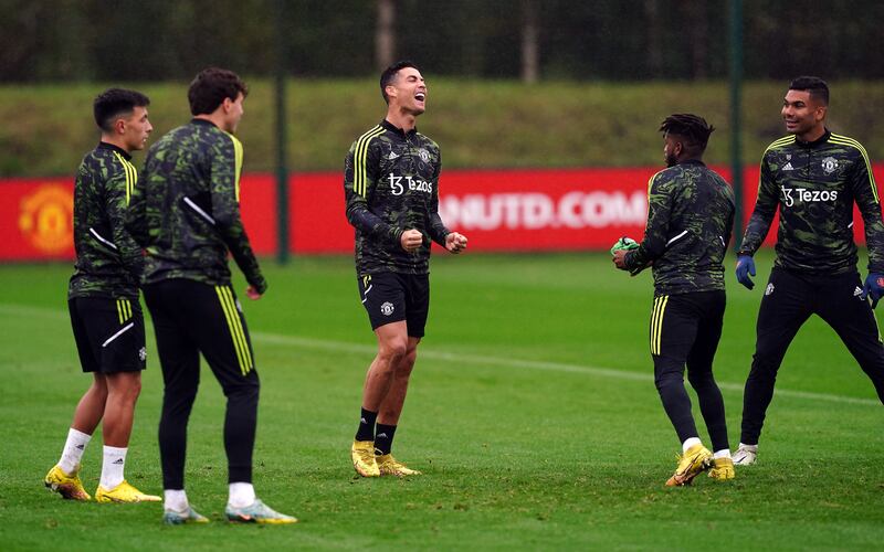 Cristiano Ronaldo laughs with Manchester United teammates at the AON Training Complex on Wednesday. PA