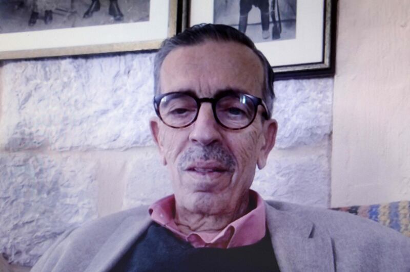 Lebanese novelist Jabbour Douaihy speaks to AFP via teleconferencing from his home in Lebanon's northern village of Ehden, as seen from the interviewer's computer in Cyprus' capital Nicosia, on May 29, 2020. Douaihy says the coronavirus pandemic, like past epidemics and wars, will feed the imagination of novelists. The novel coronavirus "will become part of the general literary scene and the imagination of humanity, just like wars, the plague… and other pandemics in history," he said, adding that while the virus will change human behaviour, it will not completely overturn our way of life. / AFP / Christina ASSI
