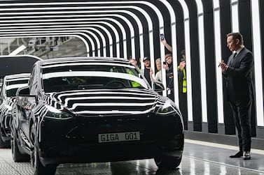 FILE - Tesla CEO Elon Musk claps hands at the opening of the Tesla factory Berlin Brandenburg in Gruenheide, Germany, Tuesday, March 22, 2022.  Tesla production stands still because of The armed conflicts in the Red Sea and the associated shifts in transport routes between Europe and Asia.  (Patrick Pleul / Pool via AP, File)